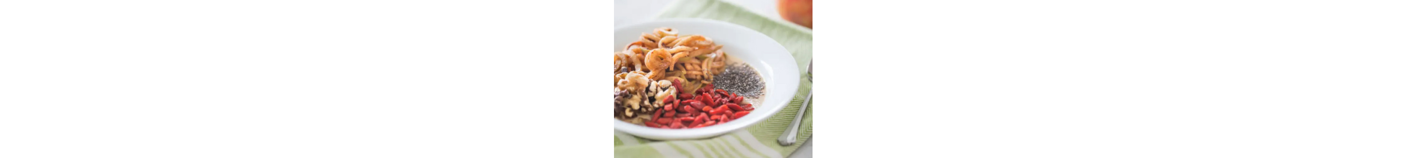 Apple pie smoothie bowl topped with apples noodles, walnuts, goji berries and chia seeds