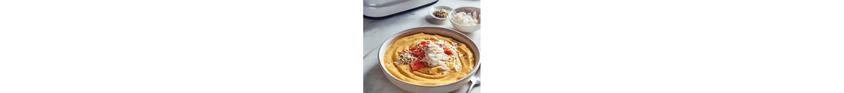 Tropical breakfast bowl topped with fruit and shaved coconut
