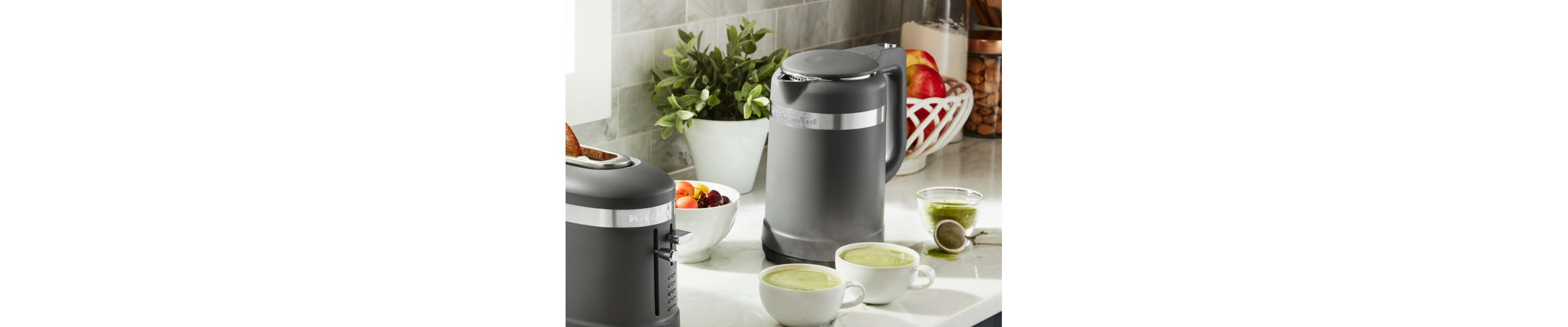 Black KitchenAid® electric kettle next to two cups of matcha