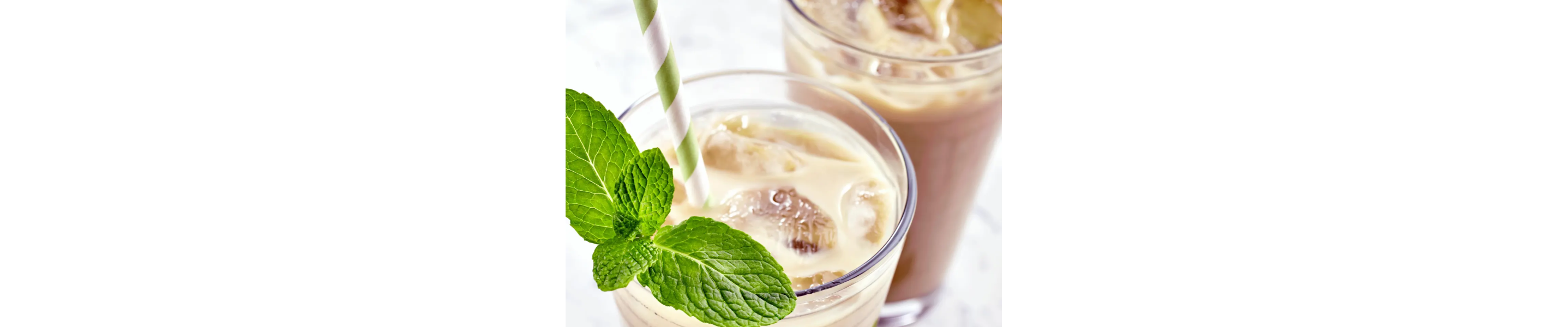 Glass of iced tea with cream and mint garnish