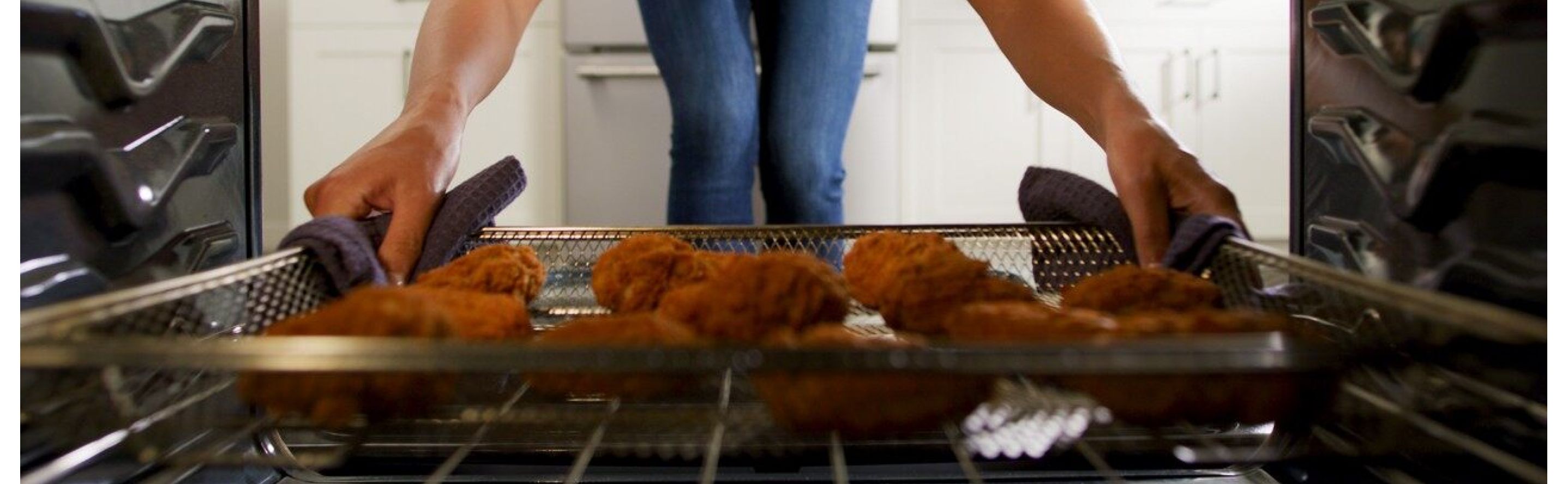 Person pulling food out of an oven