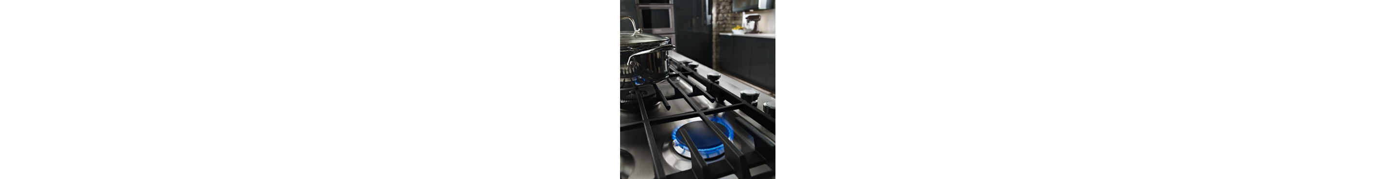 Blue flames simmering under a cooktop grate