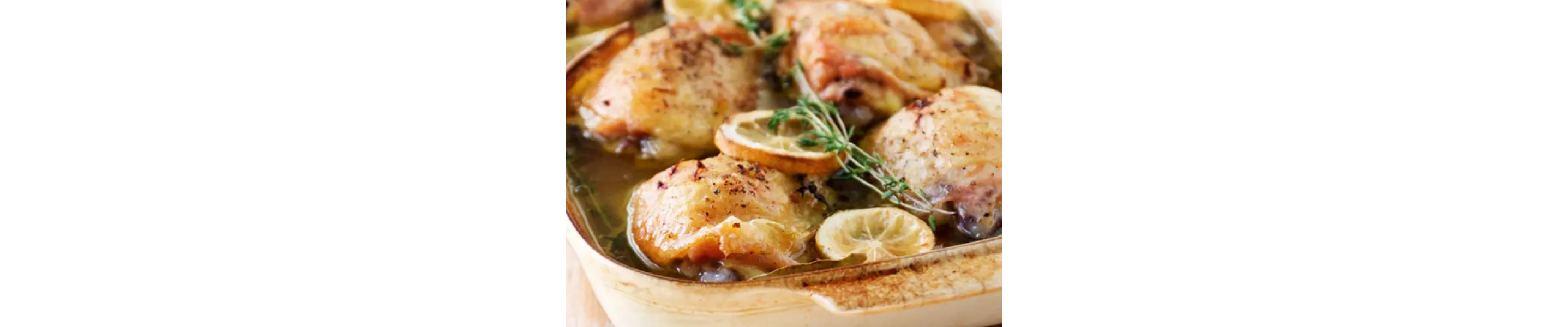 Broiled chicken with lemon peels on top.