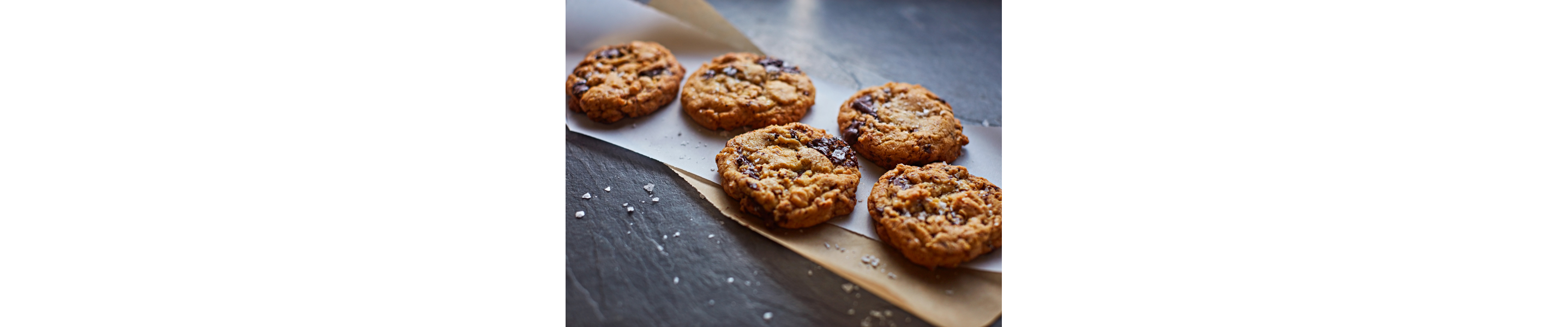  Freshly baked chocolate chip cookies on parchment paper