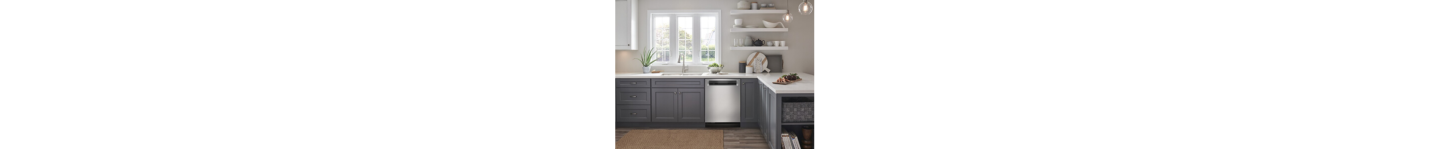 An L-shape kitchen design with gray lower cabinets, white countertops and white shelving and cabinets up top