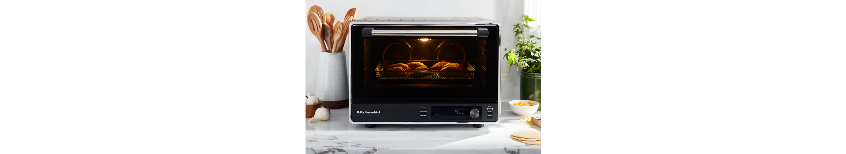 A KitchenAid® countertop oven with an air fry basket.