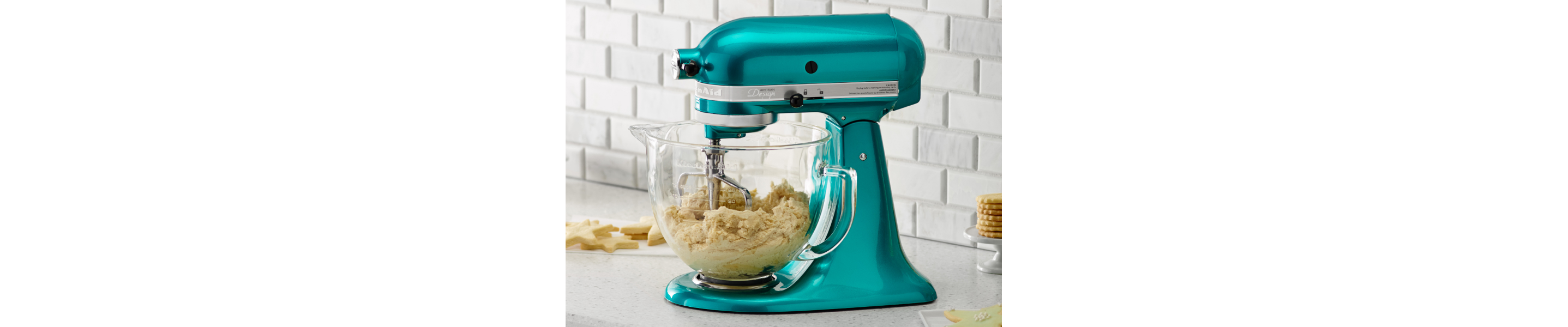 A blue stand mixer with transparent bowl