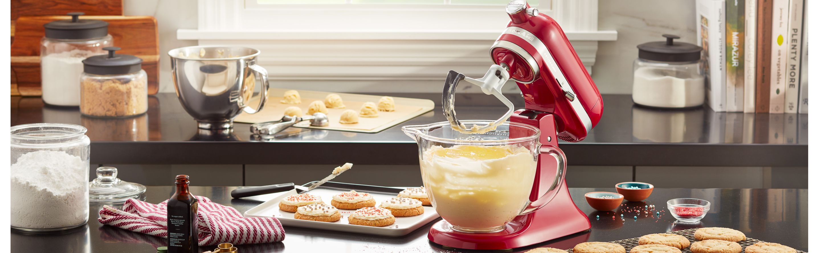 A red KitchenAid® stand mixer used to make cookie batter