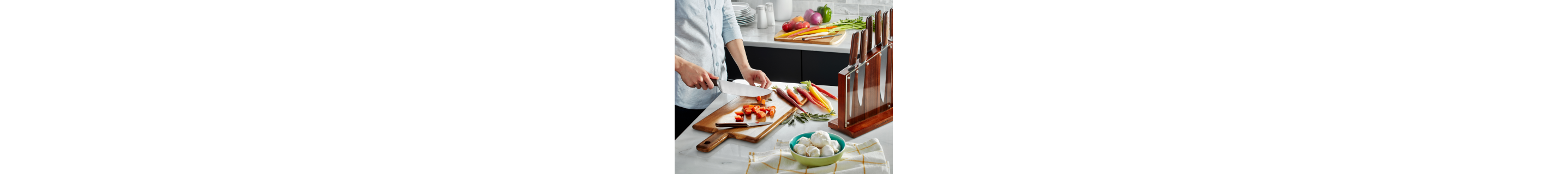 Person chopping carrots on cutting board