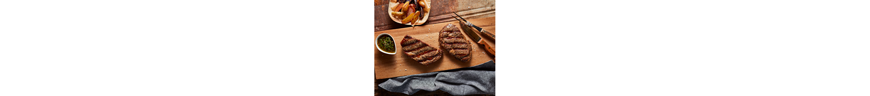 Grilled filets of steak on a serving board
