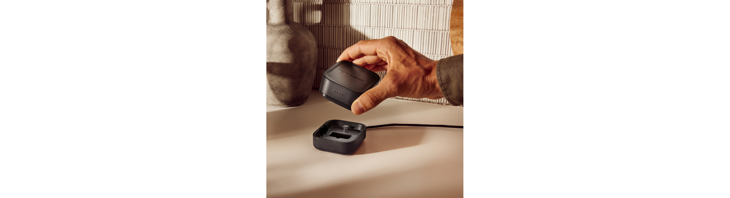 A person removing a KitchenAid Go™ Rechargeable battery from its dock.