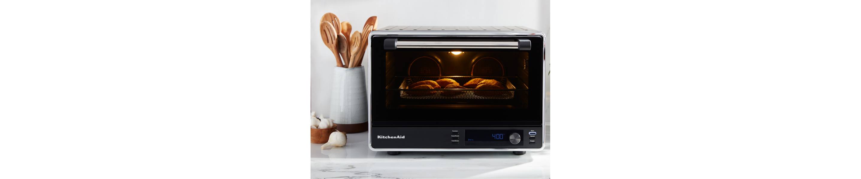 A KitchenAid® countertop oven with air fry on a modern kitchen counter. 