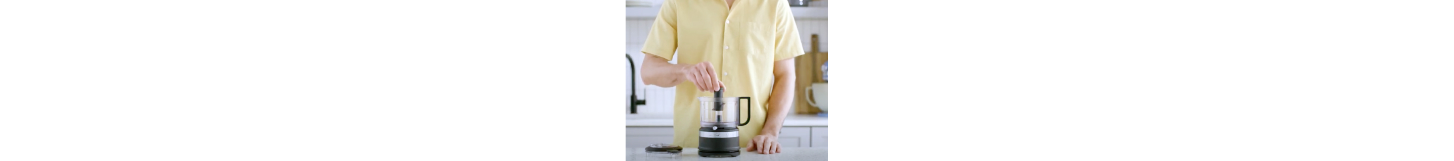 A multipurpose s-blade being attached to the food processor adaptor