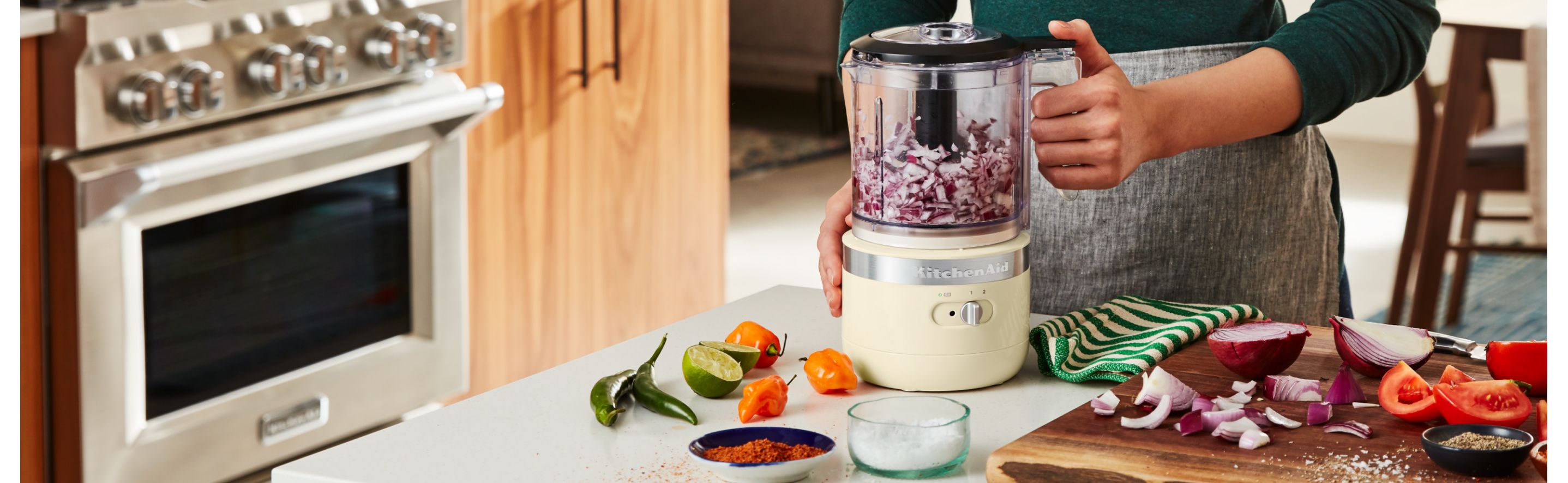 Woman chopping onions in a KitchenAid® Food Processor 