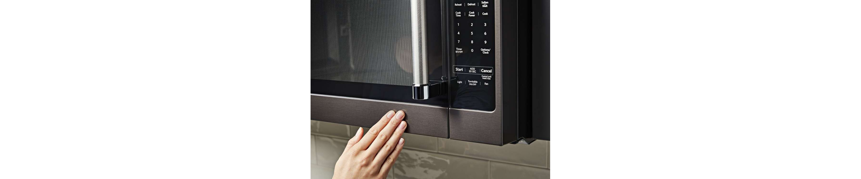 Person closing a microwave door