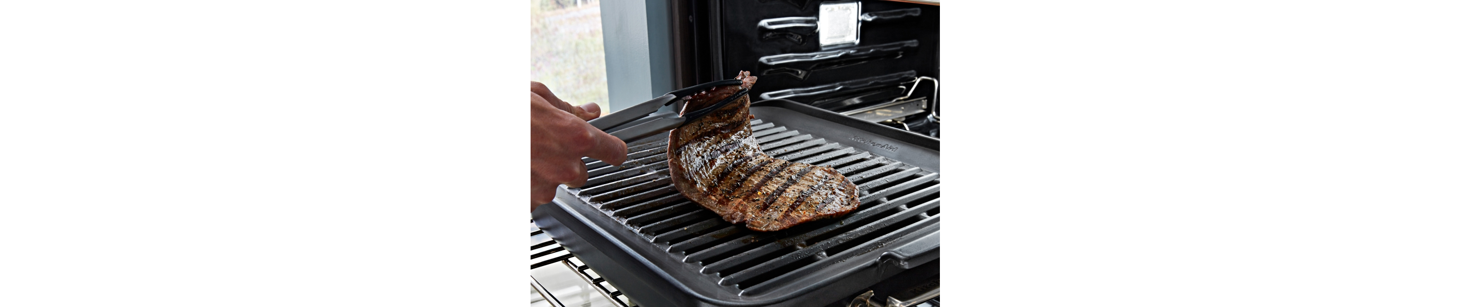 Steak being grilled inside an oven