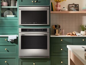 A microwave installed within cabinetry, above a wall oven