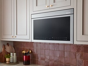 A flush KitchenAid® microwave, surrounded by pale cabinetry