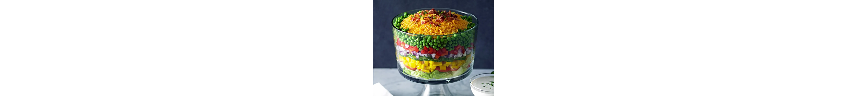 Layered veggie salad in glass bowl from Yummly recipe
