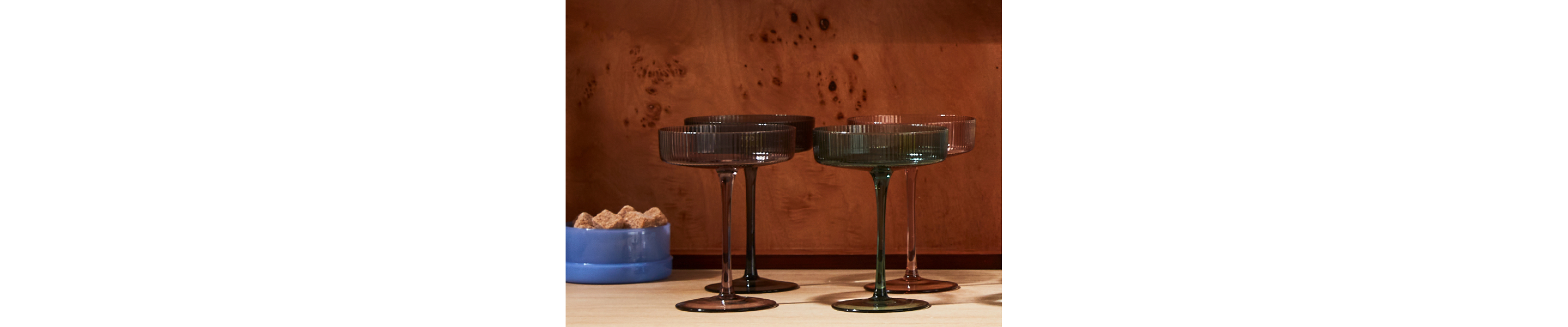 Dark colored martini glasses on a counter top