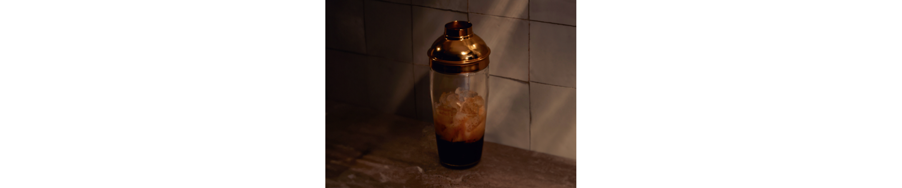 Espresso martini ingredients in a glass cocktail shaker