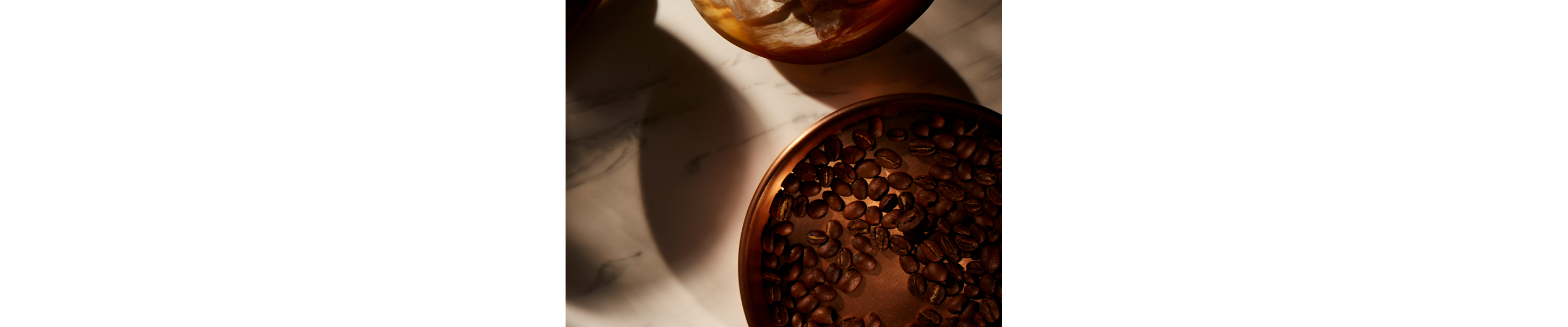 Copper bowl filled with coffee beans
