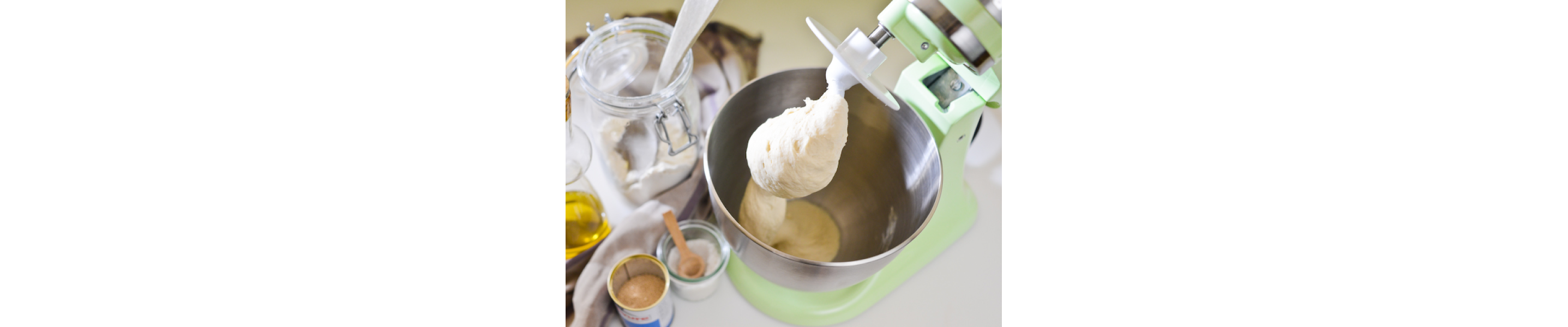 Dough being mixed with a dough hook in stand mixer bowl