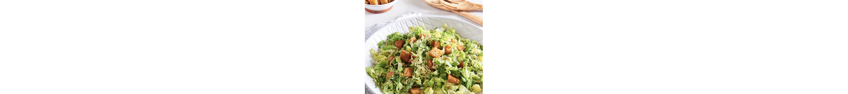 A homemade Caesar salad topped with croutons.