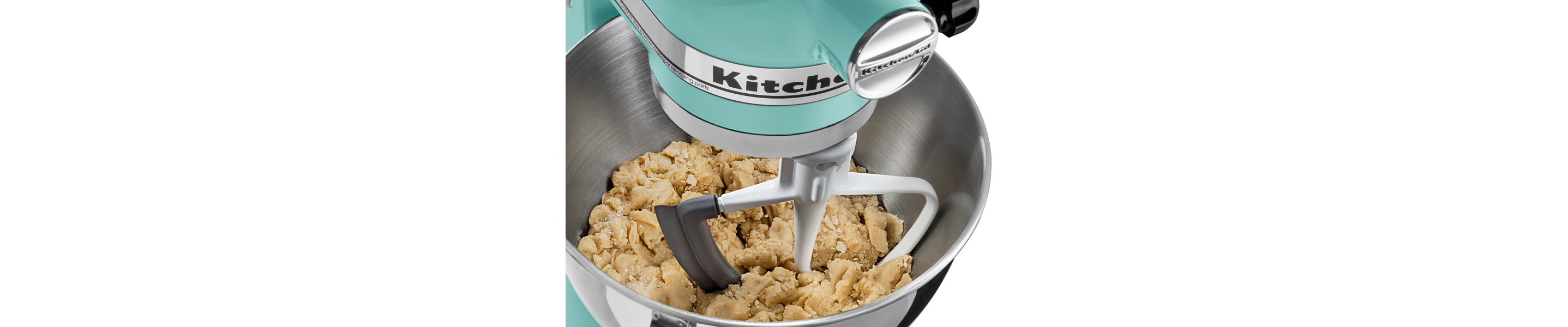 A teal KitchenAid® stand mixer with Flat Beater Attachment used to mix cookie dough