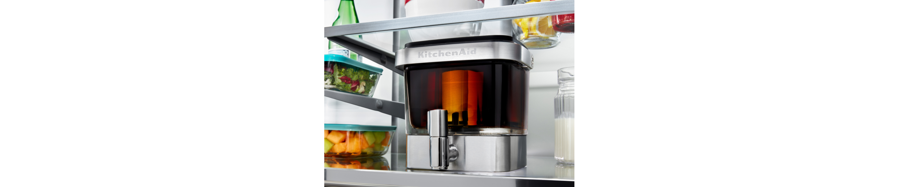 A filled KitchenAid® cold brew maker in a fridge