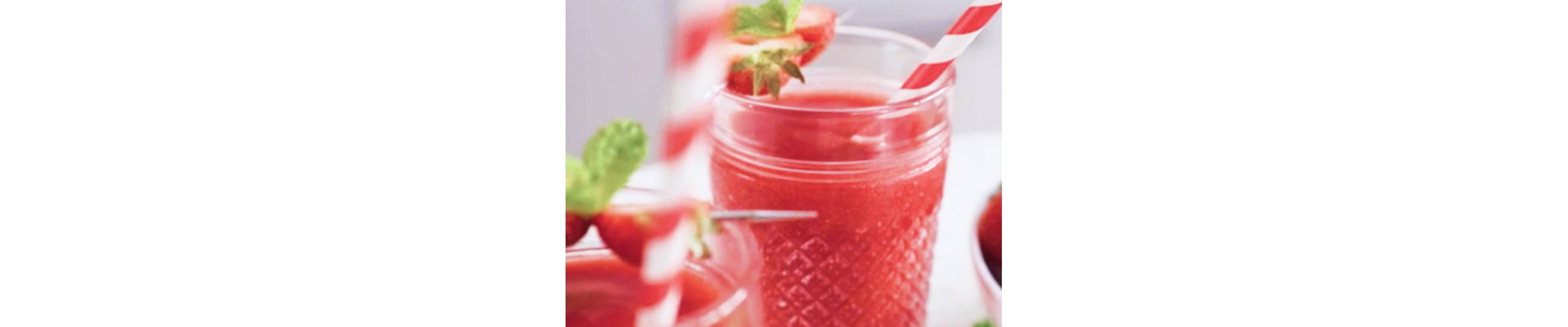 Frozen strawberry lemonade with red and white straws