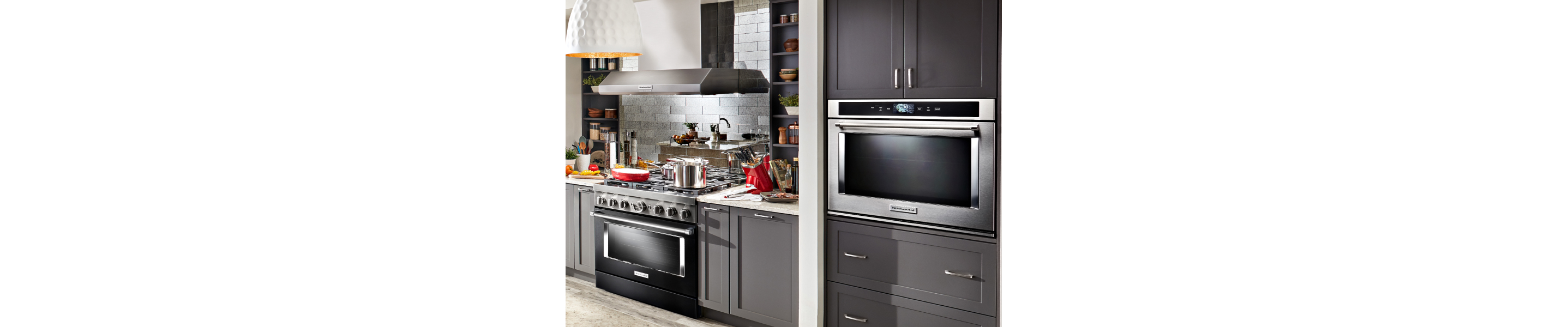 Kitchen with gray cabinetry, gas range and single wall oven 