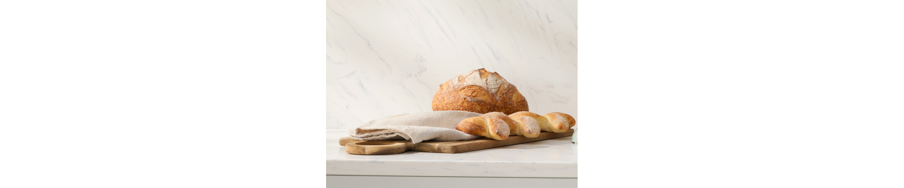 Assorted bread sitting on a countertop.
