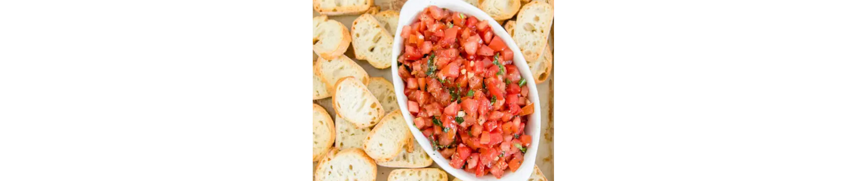 Bruschetta mixed in a bowl, ready to top bread.