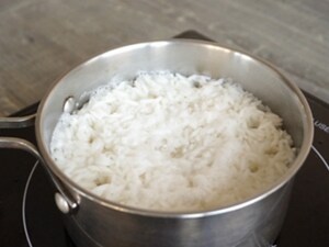 A bowl of rice on a burner