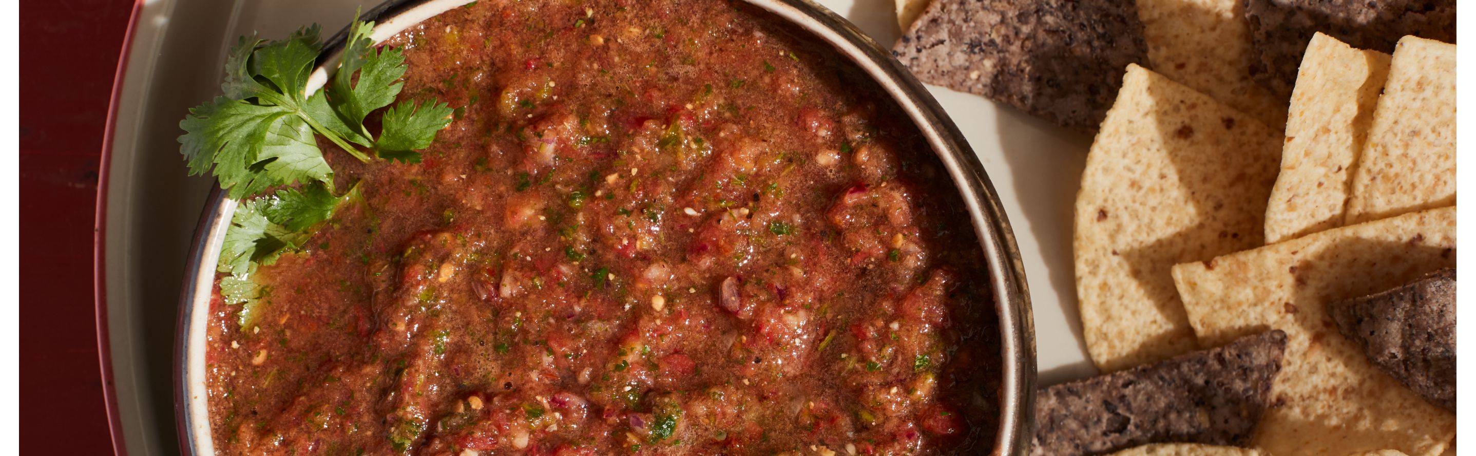 A bowl of blender salsa and chips