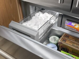 A freezer drawer pulled out with a full ice bin