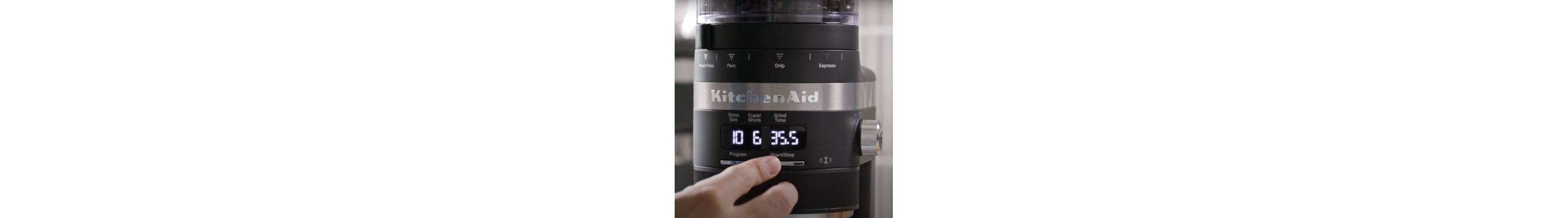 Hand selecting a dosage setting on a burr grinder