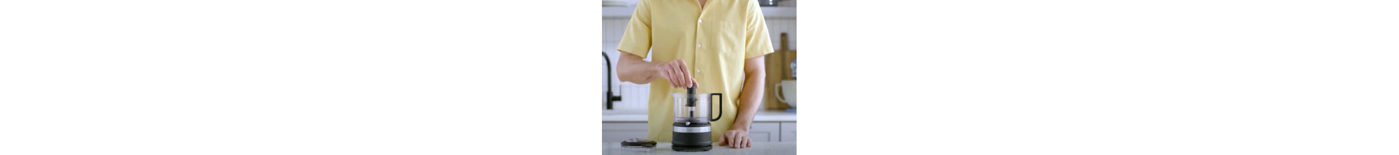Person assembling black food chopper