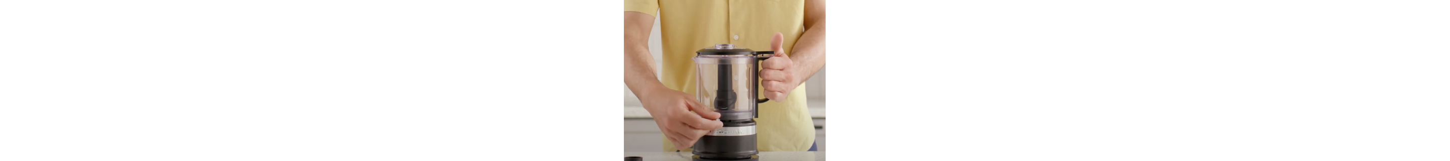 Person adjusting controls on food chopper