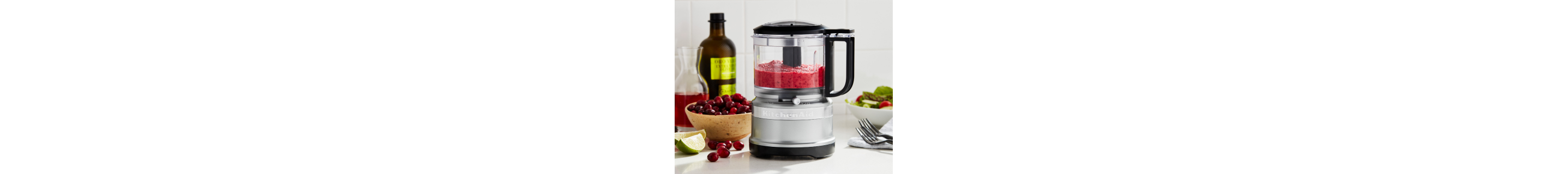 Silver food chopper filled with pureed fruit