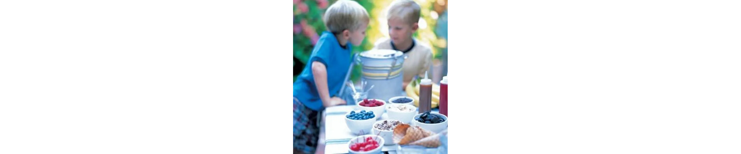 Two children at an ice cream sundae bar