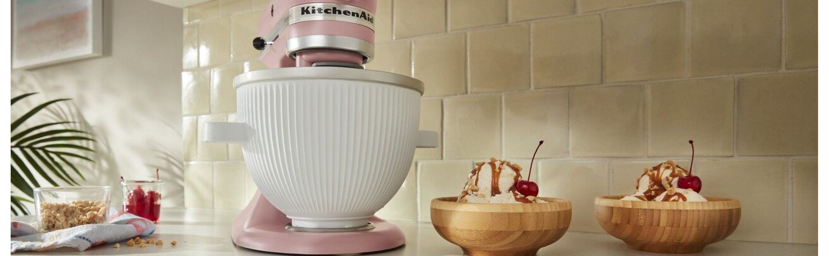 Pink KitchenAid® stand mixer next to two ice cream sundaes