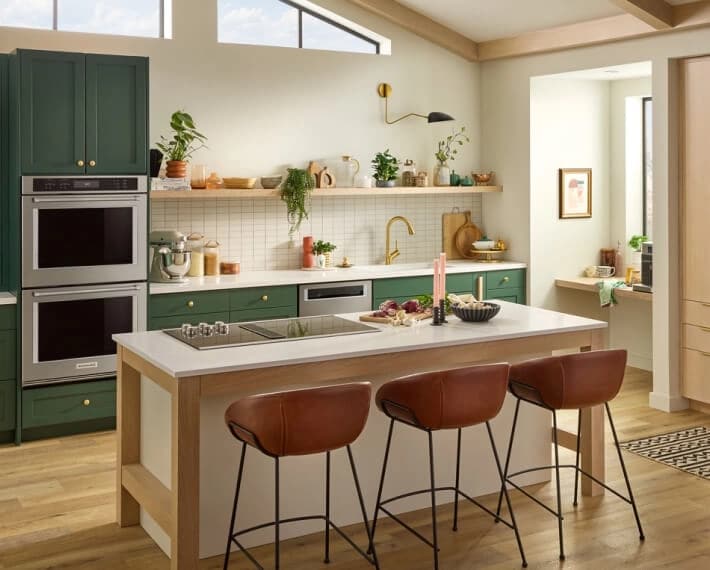 A kitchen island with natural-looking wood accent