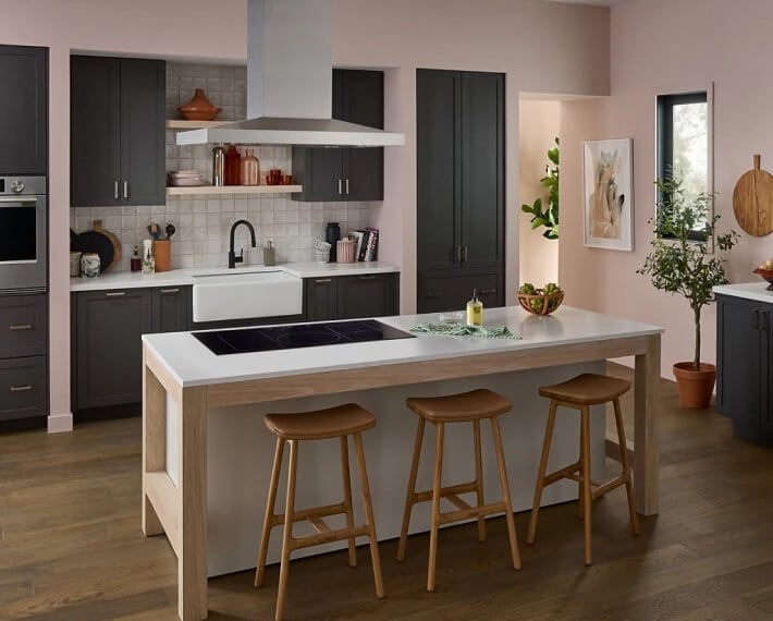 A modern looking kitchen with an island with a cooktop