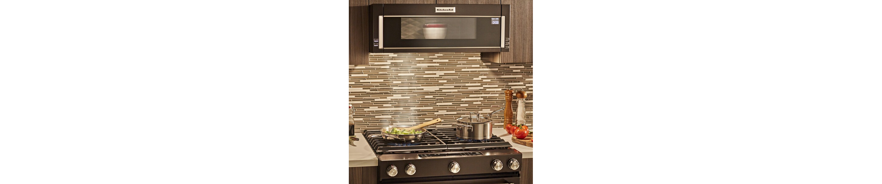 Dish heating in a black stainless, KitchenAid® low profile microwave above stovetop