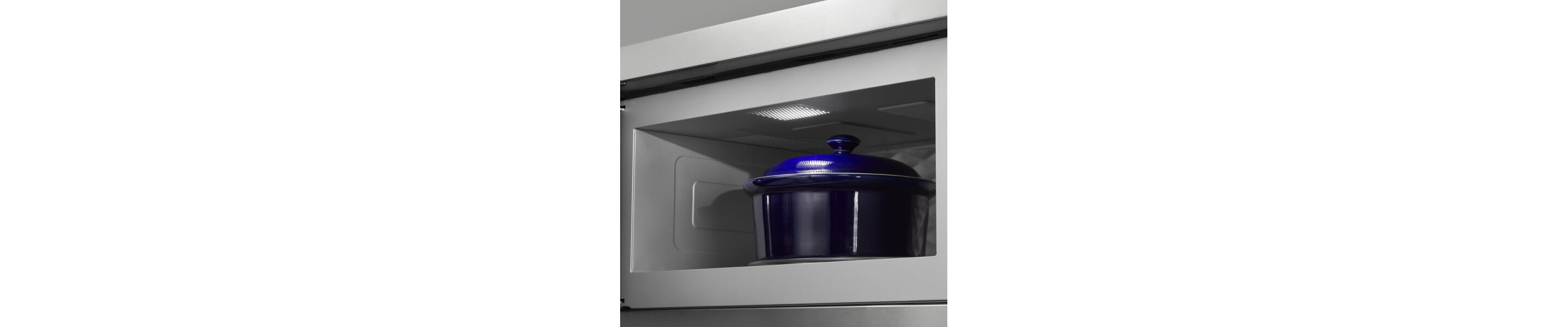 Blue ceramic pot with lid in the cavity of a low profile microwave