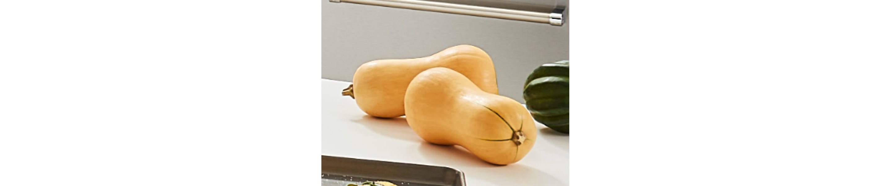 Two medium-sized butternut squashes on a counter