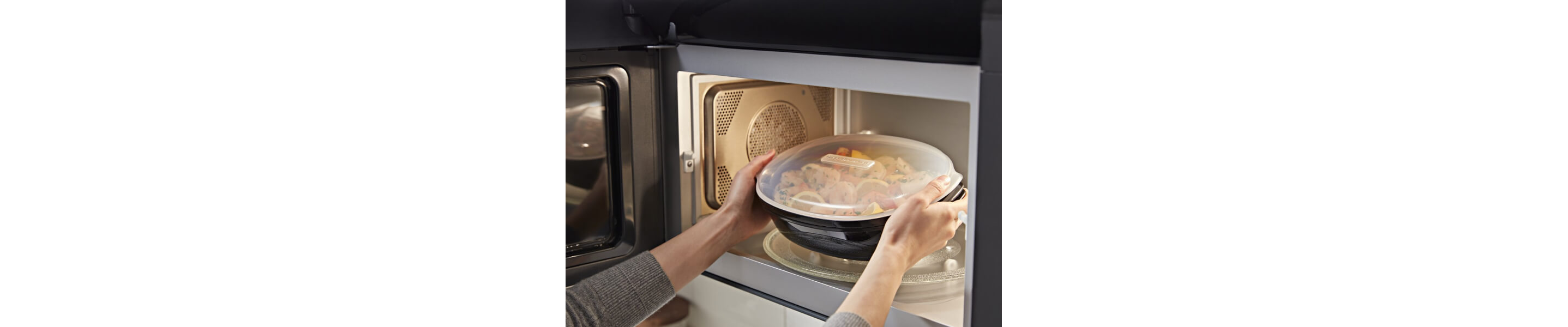  Person microwaving veggies in a microwave-safe container
