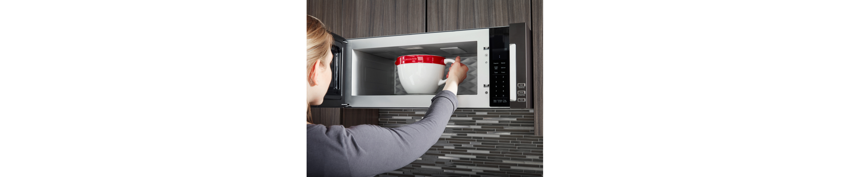 Person removing bowl from microwave